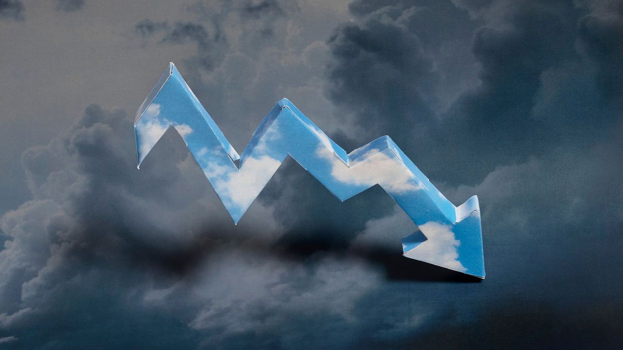 An image showing a three-dimensional stock line arrow made out of an image of a blue sky with clouds. It is pointing downwards, and set against a dark cloudy sky.